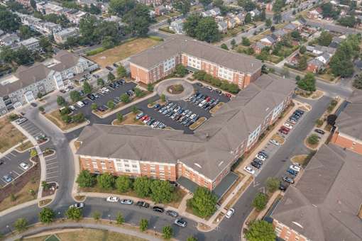 an aerial view of a large brick building with a grey roof
