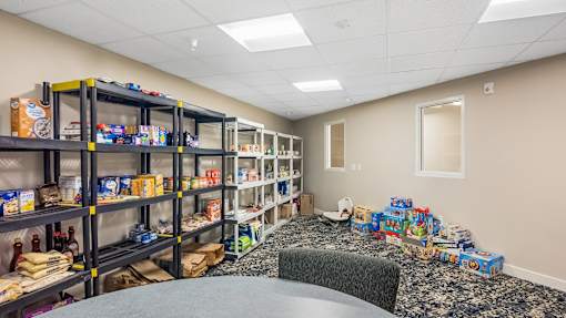 A storage room with shelves filled with boxes and items.