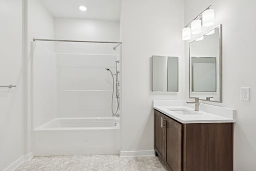 A white bathroom with a white tub and sink.