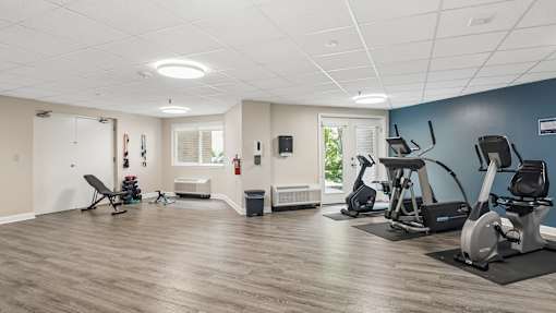 A spacious gym with a variety of exercise equipment.