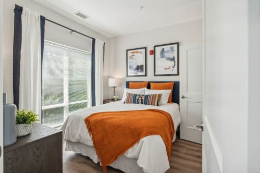 Bbedroom with a bed and a large window at Legacy at Twin Rivers