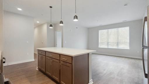 A kitchen with wooden cabinets and a white countertop.