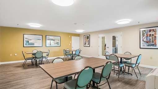 A conference room with a long table and chairs.