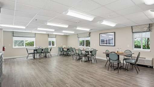 A room with tables and chairs is empty and ready for an event.