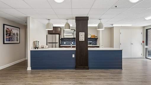 A reception area with a blue counter and a brown pillar.