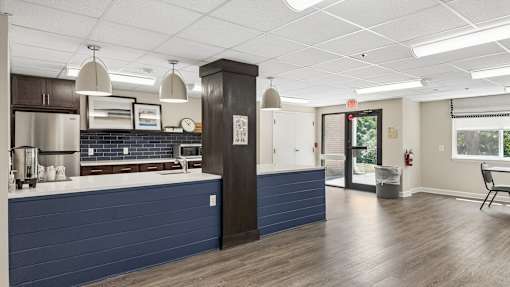 A kitchen with a blue counter and a white ceiling.