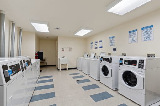 a laundry room with washers and dryers