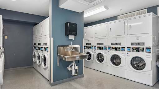 A row of washing machines in a laundromat.
