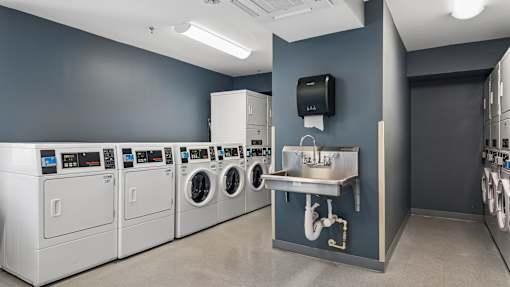A row of washing machines in a laundry room.