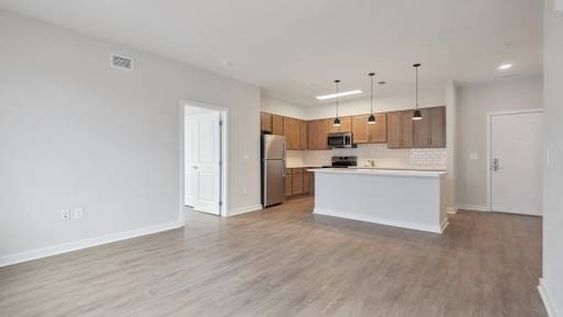 A kitchen with wooden cabinets and a white island.
