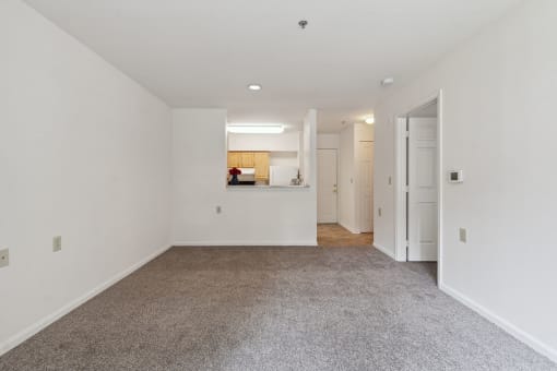 a bedroom with white walls and carpet