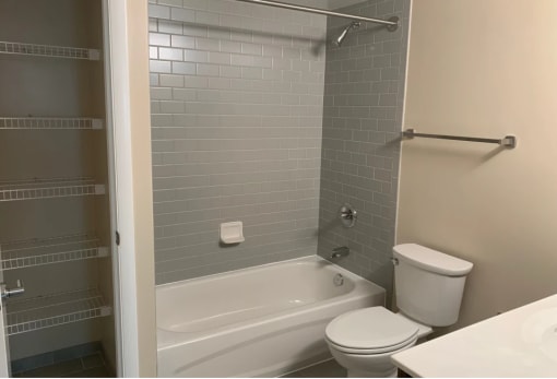 Bath and linen storage at Randle Hill affordable apartment community located in Washington, DC