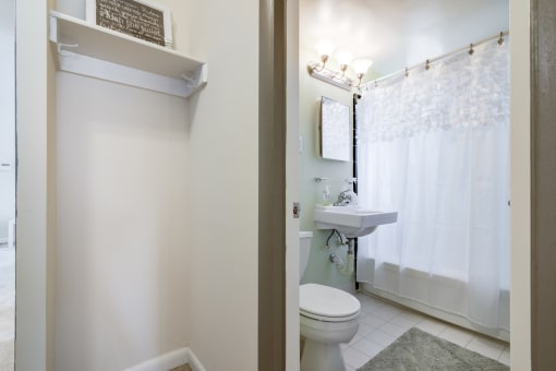 Clean and functional bathroom inside Meadowbrook Run apartment featuring contemporary fixtures, ample lighting, and easy-to-maintain surfaces.