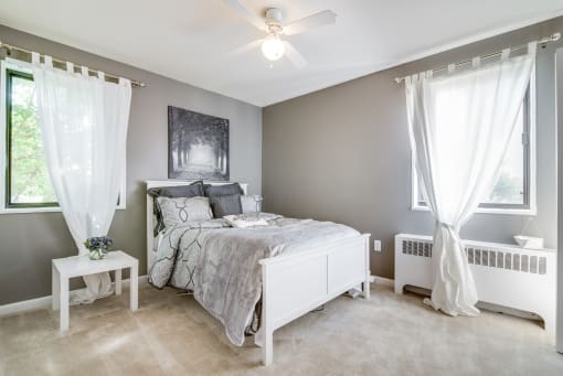 Comfortable bedroom with generous space, bright windows, and neutral tones at Meadowbrook Run, ideal for creating a restful personal retreat in Southeast Washington, D.C.