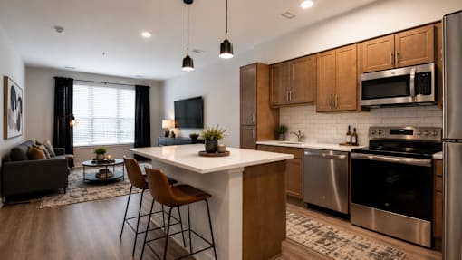 A modern kitchen with a large island and stainless steel appliances.