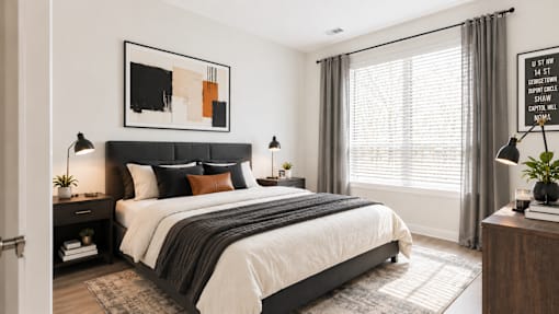 A modern bedroom with a large bed and a painting above it.
