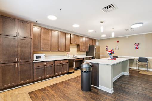 A kitchen with wooden cabinets and a white counter.