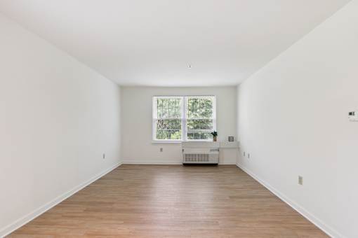 A room with wooden floors and a window.