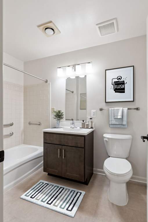 Accessible bathroom in Park Heights Place senior housing with stall shower, supportive grab bars, and modern fixtures for safety and comfort.