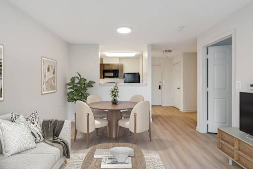 Bright dining room in a Park Heights Place senior apartment with stylish flooring, warm lighting, and space for shared meals.