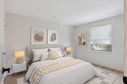 A bedroom with a large bed and a window.