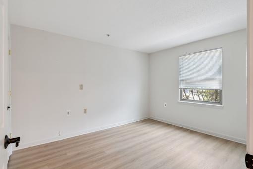 Cozy senior apartment bedroom at Park Heights Place with soft lighting, generous closet space, and warm, inviting décor.