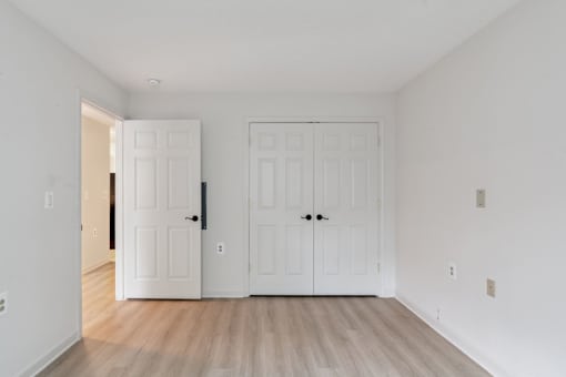 Cozy senior apartment bedroom at Park Heights Place with soft lighting, generous closet space, and warm, inviting décor.