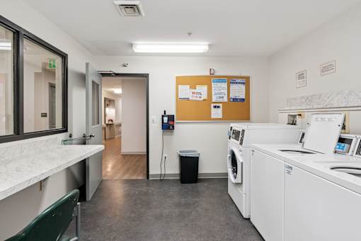 Accessible on-site laundry room at Park Heights Place senior apartments for resident convenience.