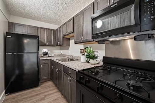 Modern kitchen in a 2-bedroom apartment at Edgewood Commons 611 & Gardens, showcasing energy-efficient appliances, ample cabinet storage, and sleek finishes—offering both style and functionality for everyday living.