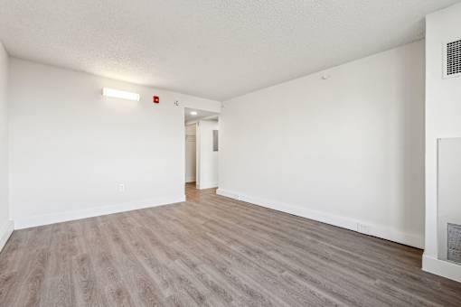 Bright, airy bedroom in a market-rate 2-bedroom apartment at Edgewood Commons 611 & Gardens, with generous closet space, luxury vinyl flooring, and plenty of natural light—ideal for comfort and rest.
