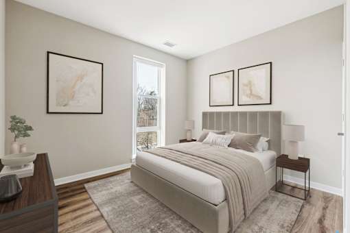 A bedroom with a large bed and two framed pictures on the wall.