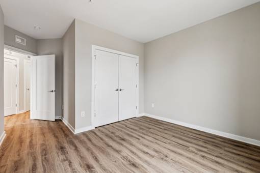 A room with a wooden floor and white walls.