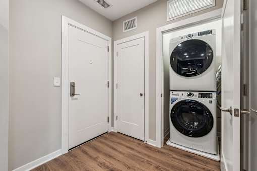 A white door with a black handle is on the left side of the image.