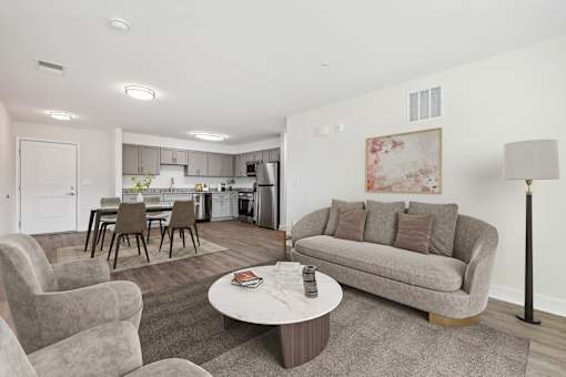A living room with a grey couch and a coffee table.