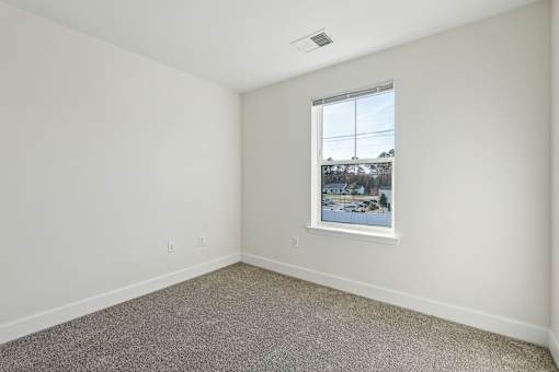 A room with a window showing a view of a snowy landscape outside.