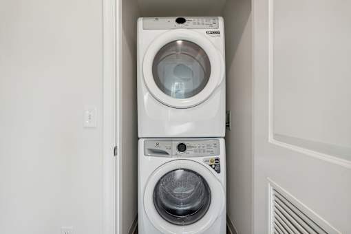 A white washing machine and dryer in a small laundry room.