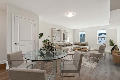 A modern dining room with a glass table and chairs.