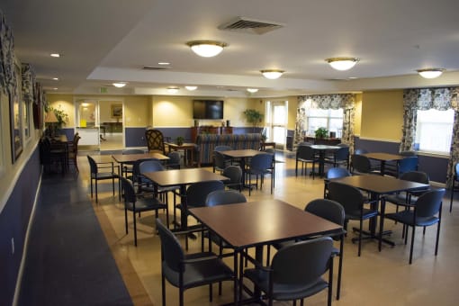 A large community room with tables and chairs.