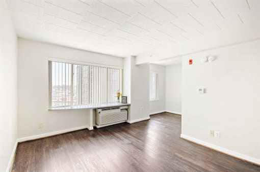 Spacious living room inside a market-rate apartment at Edgewood Commons 601 featuring hardwood floors, bright natural light, and energy-efficient appliances in Washington, DC.