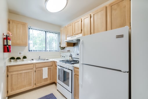 Modern, fully equipped kitchen at Meadowbrook Run Apartments with energy-efficient appliances, sleek cabinetry, and updated finishes in a bright, open-concept layout.