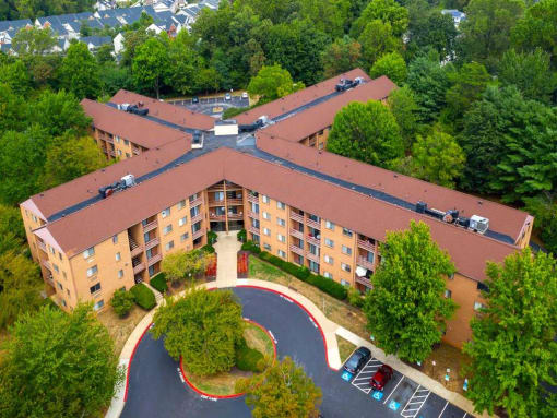 Mid-rise apartment building at College Parkway Place featuring elevator access, controlled entry, off-street parking, and landscaped grounds in the heart of Annapolis, MD.
