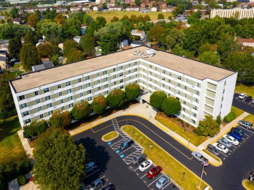 large white building with a parking lot in front of it