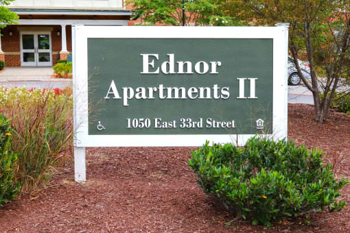 a sign in front of a building that says edroit apartments ii