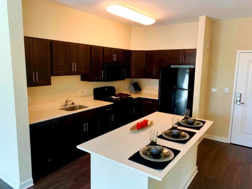 Sleek, modern kitchen with large island at Metro Heights apartment community near downtown Baltimore.