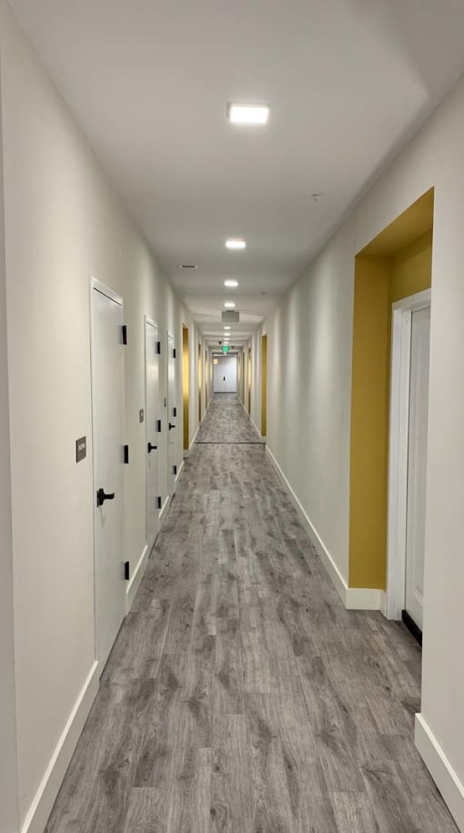 Well-lit hallways and interior apartment home entry at Metro Heights in Baltimore.