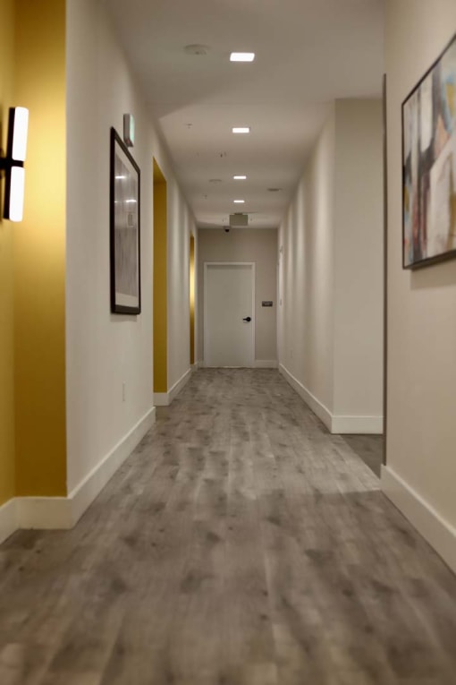 Well-lit hallways in apartment home entry from interior of the building at Metro Heights in Baltimore.