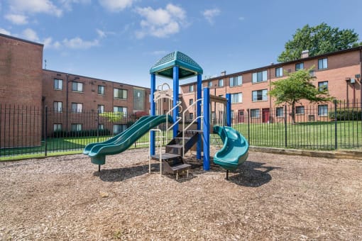 On-site playground at Meadowbrook Run Apartments in Congress Heights, Washington, D.C., featuring safe, modern play structures surrounded by green space—offering a fun and active outdoor area for children and families in the community.