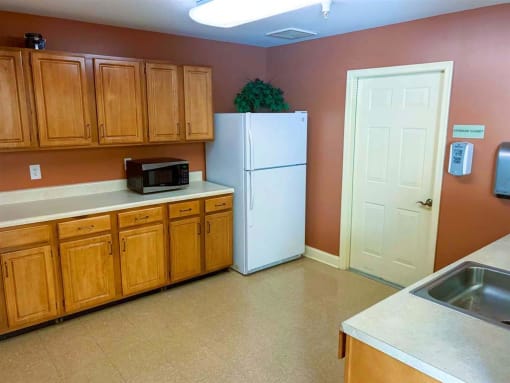 Spacious community room featuring large shared kitchen at Park View at South Pantops where residents age 62 and better enjoy social events, educational activities, and entertainment opportunities.