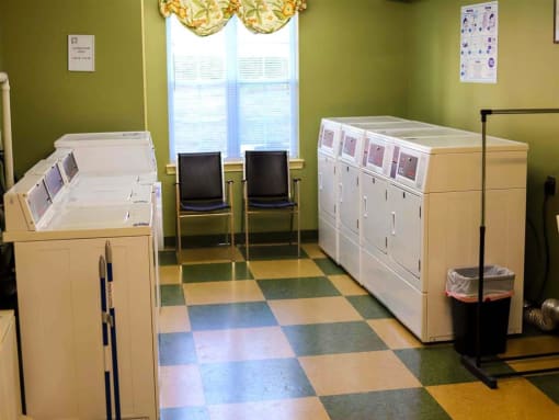 On-site laundry facility at Park View at South Pantops, featuring multiple washers and dryers in a clean, well-lit space for the convenience of senior residents age 62 and better.