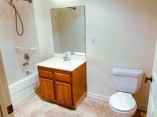 Well-lit bathroom featuring enhanced safety features and medical emergency pull cords, designed with seniors' needs in mind at Park View at South Pantops.